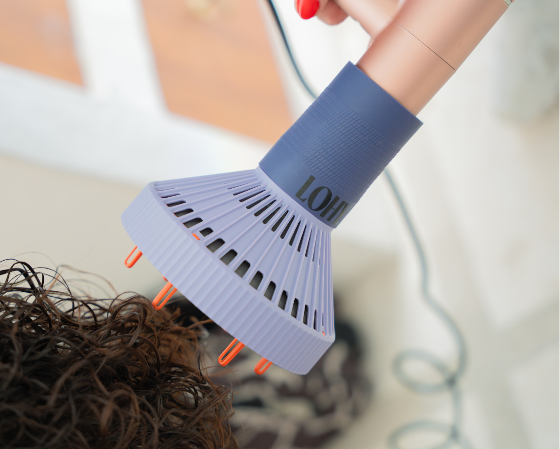 LOHY. Curl Flow Diffuser attached to dryer being used on curly hair