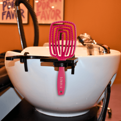 LOHY. Pink Paddle Brush sitting on salon basin
