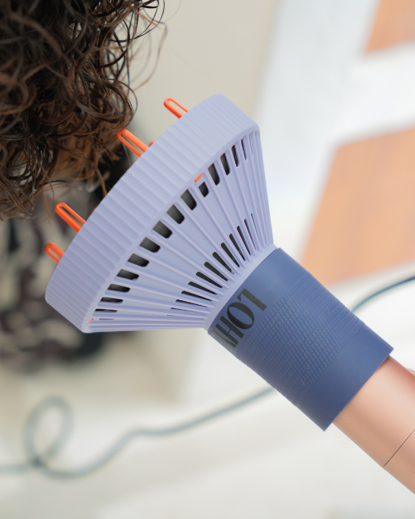 LOHY. Curl Flow Diffuser being used on rose gold hairdryer, drying curly hair