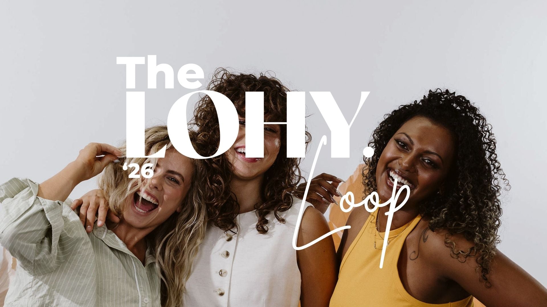 The LOHY. Loop 2026 logo, curly haired women smiling and laughing together