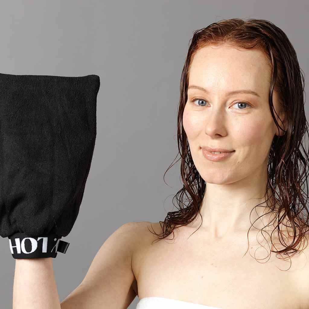 Red curly girl with wet hair holding the LOHY glove